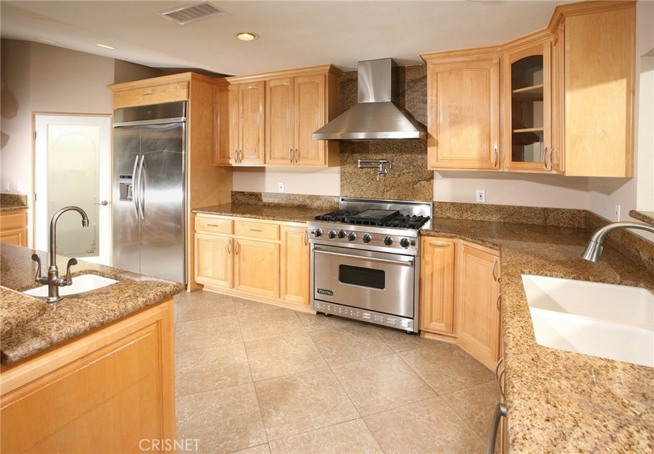 The chef in the family  is going to truly appreciate the gourmet family kitchens recessed lighting, abundant maple wood cabinetry, rich granite counter tops with back-splash, walk-in pantry, under-mount dual basin sink with modern faucet, Viking Prof