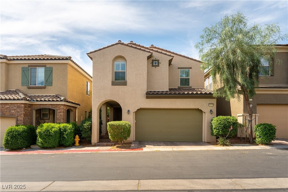 View of front of house with stucco siding, an atta