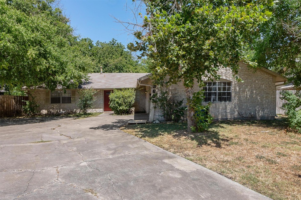 View of front of property with brick siding and a