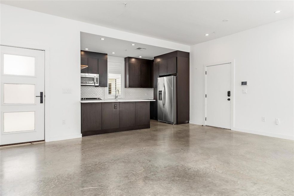 Kitchen featuring stainless steel appliances, bac