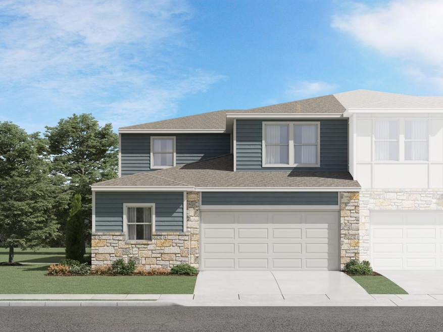 View of front of home featuring stone siding, roo