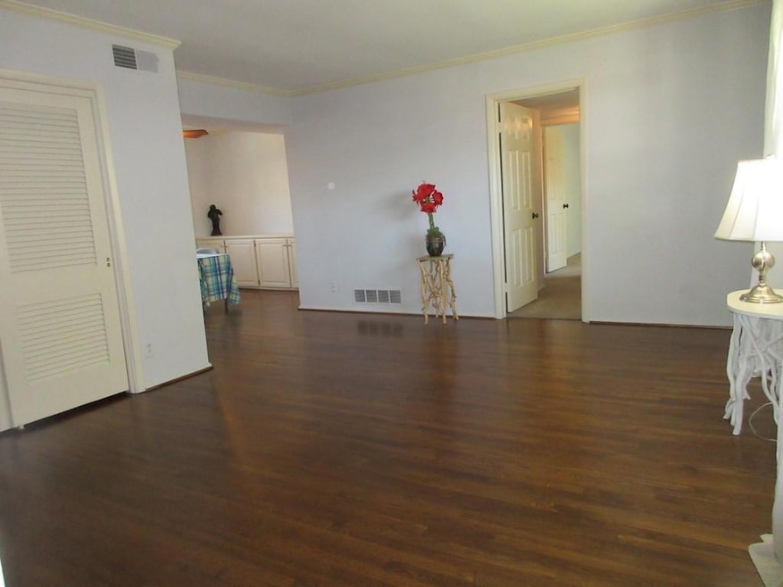 Unfurnished room featuring dark wood-style floors,