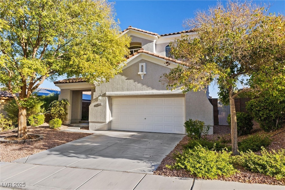 View of front of home with driveway, stucco siding