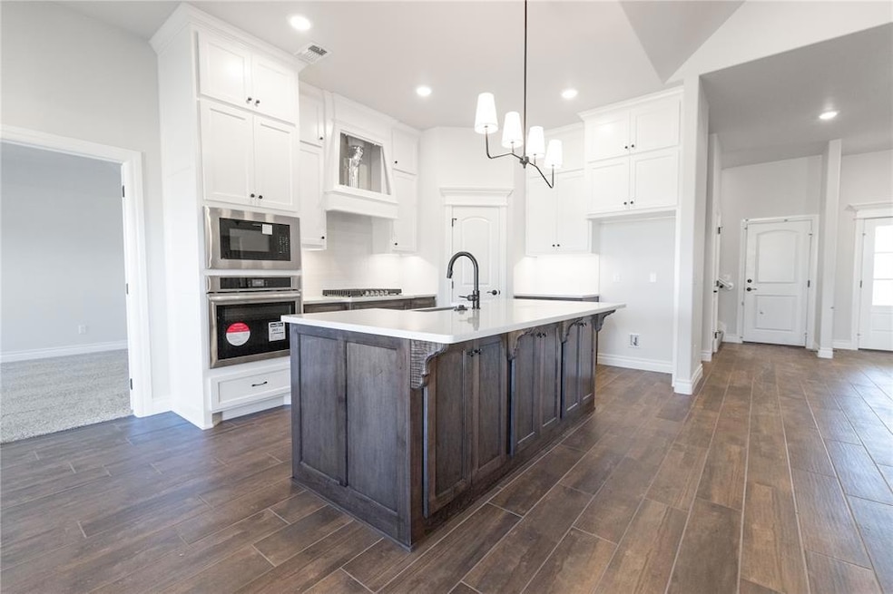 Kitchen with built in microwave, oven, stovetop, a
