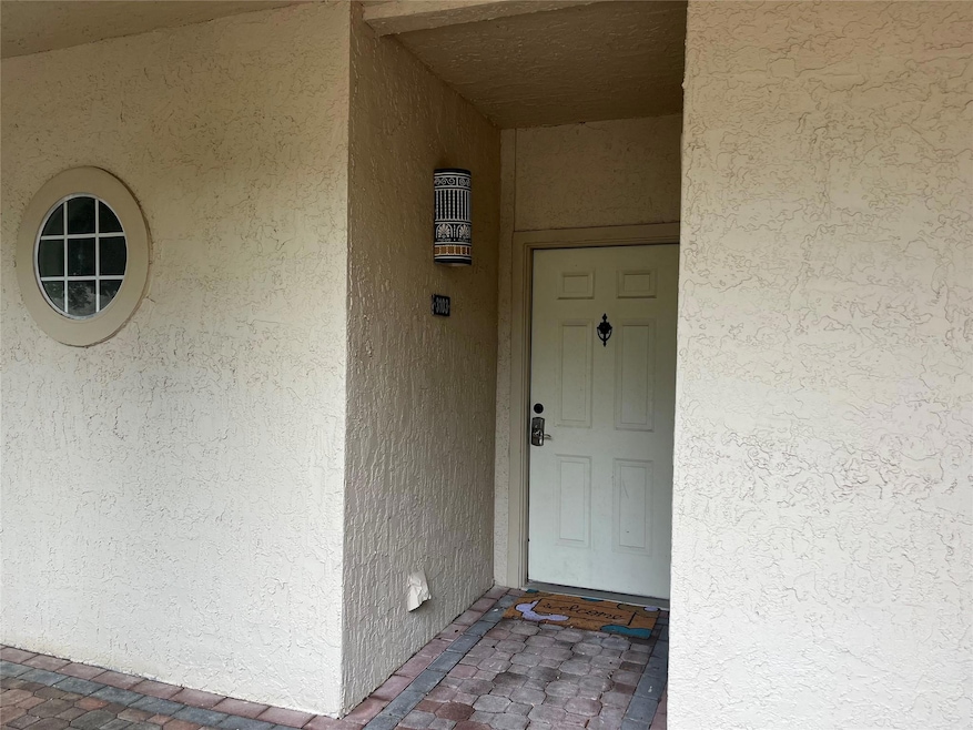 Property entrance featuring stucco siding