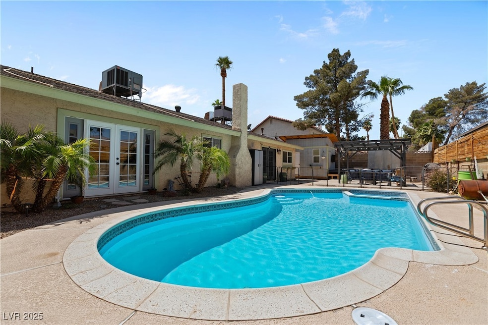 View of pool featuring french doors, a fenced in p