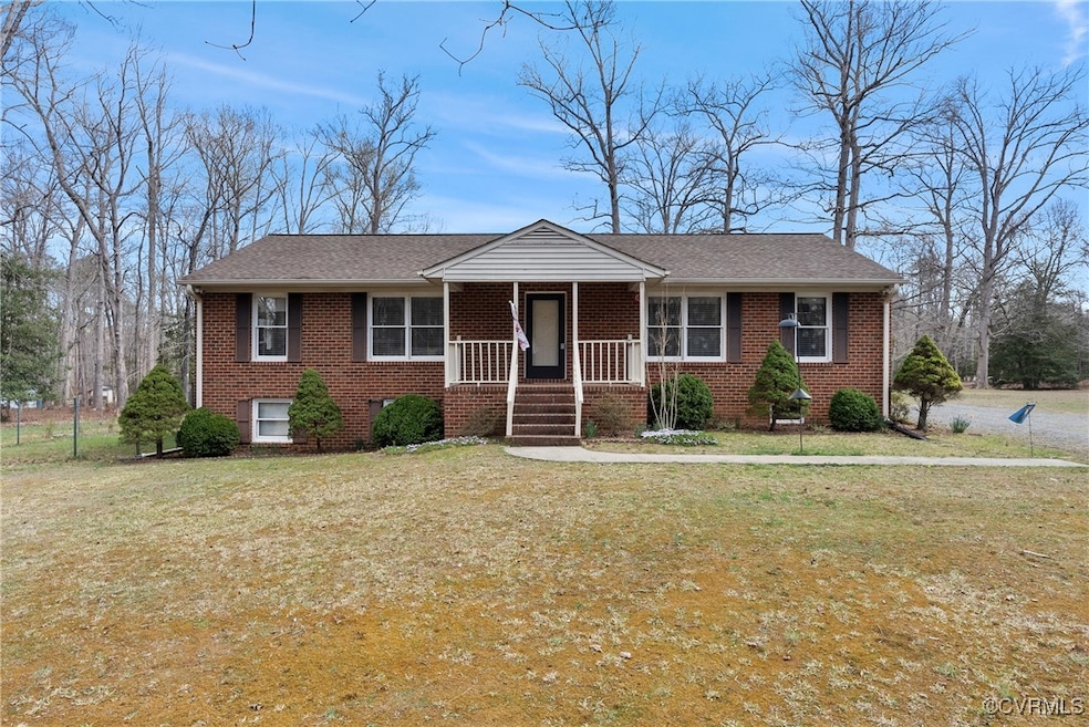 View of front of house featuring a front yard, cov