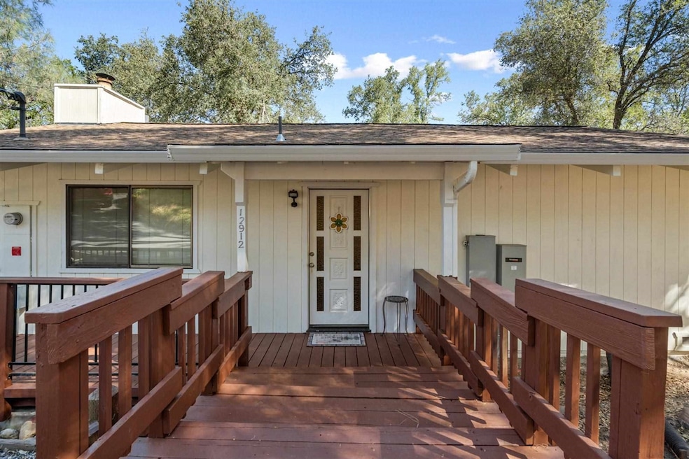View of exterior entry with a wooden deck