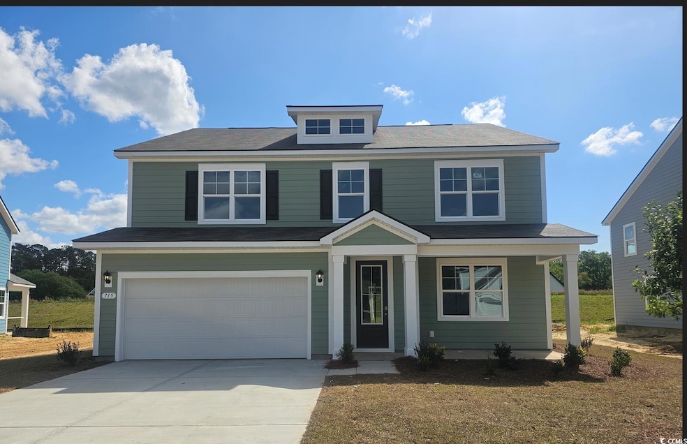 Traditional-style home featuring driveway, covered