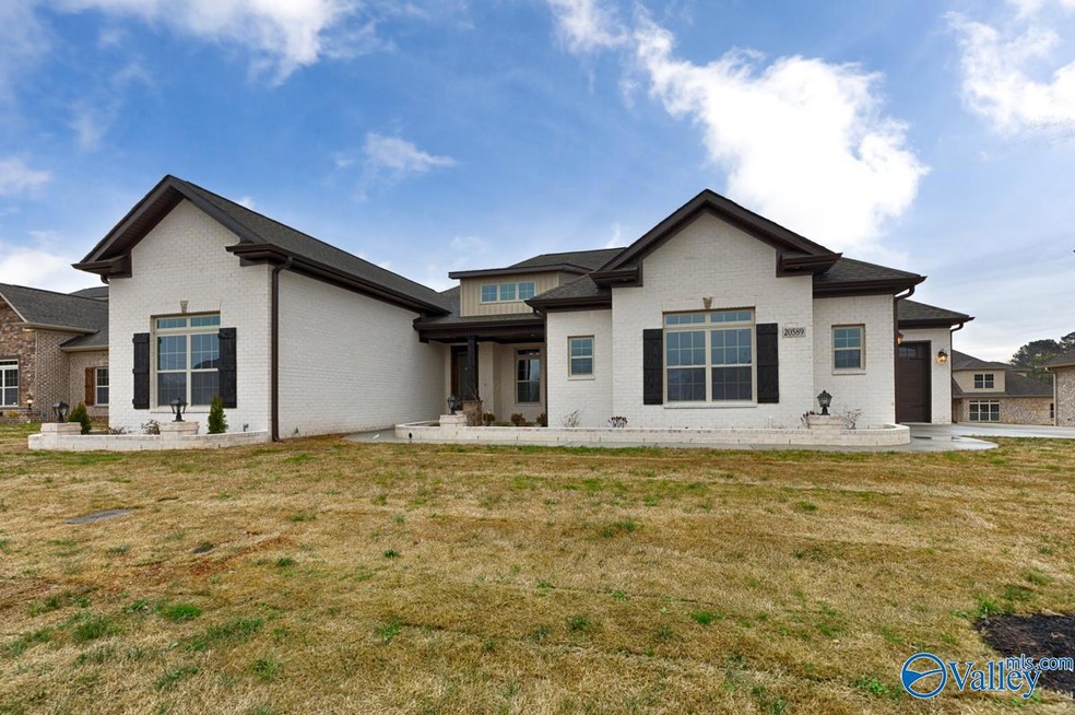 Homeridge B features all ranch style 4 bedroom 3.5 bath home with a glass sliding wall from the gathering room opening up to the screened covered veranda with outdoor fireplace.
