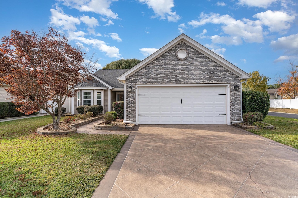View of front of property with a garage and a front lawn