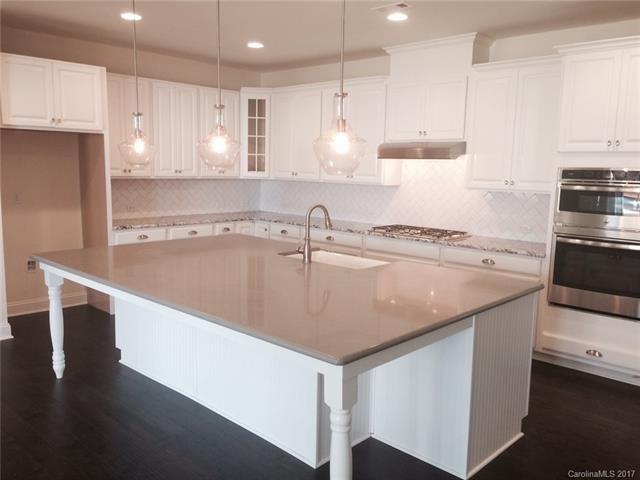 Quartz countertops, beautiful hardwoods, tile back