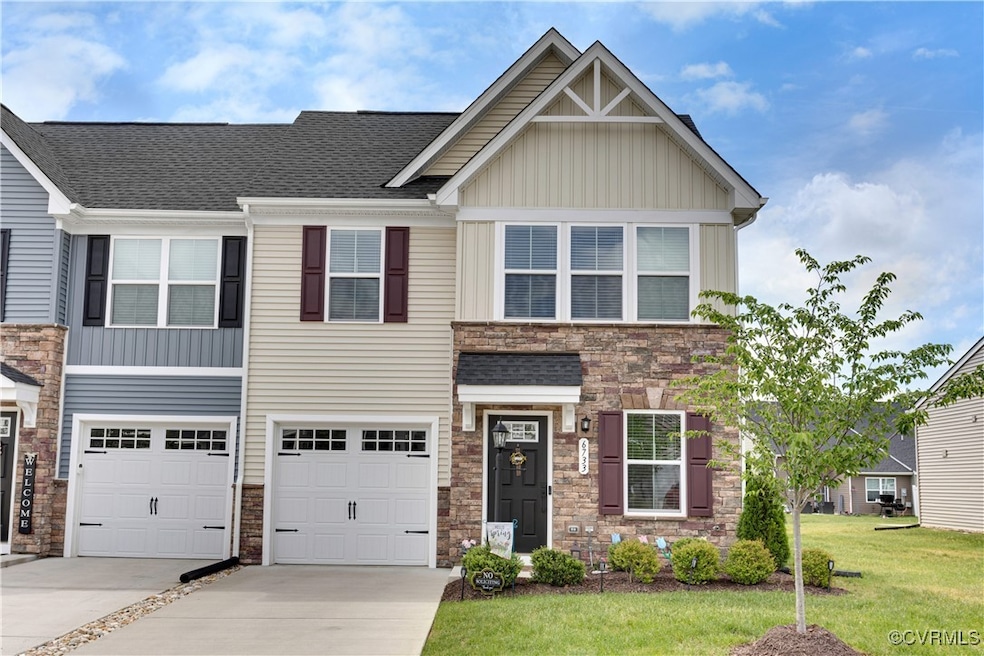 View of front of home with concrete driveway, ston