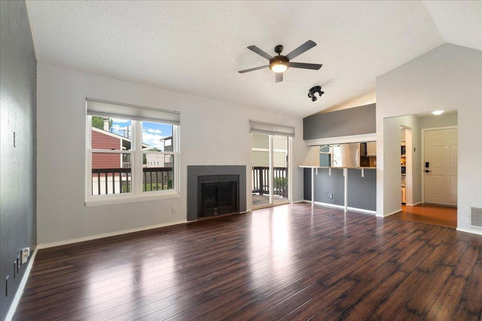 Unfurnished living room featuring lofted ceiling,
