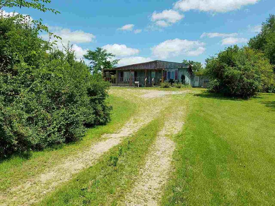 Front of home and gravel drive.