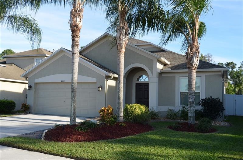 Bursting with curb appeal - mature palms, cement l