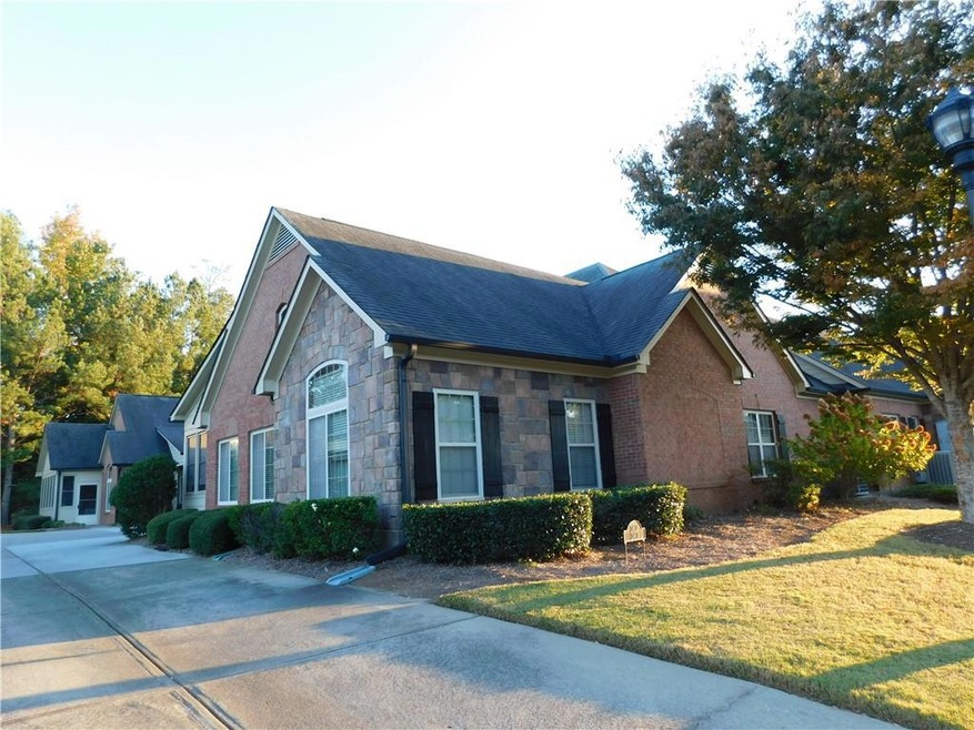 View of side of home with a yard