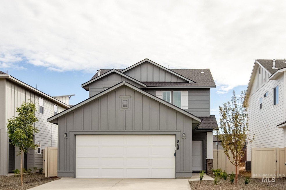 View of front facade featuring board and batten siding, a shingled roof, driveway, and an attached garage