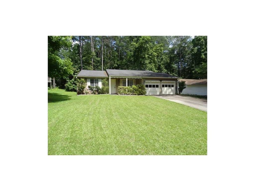 Exterior Front. Ranch home on level wooded lot.