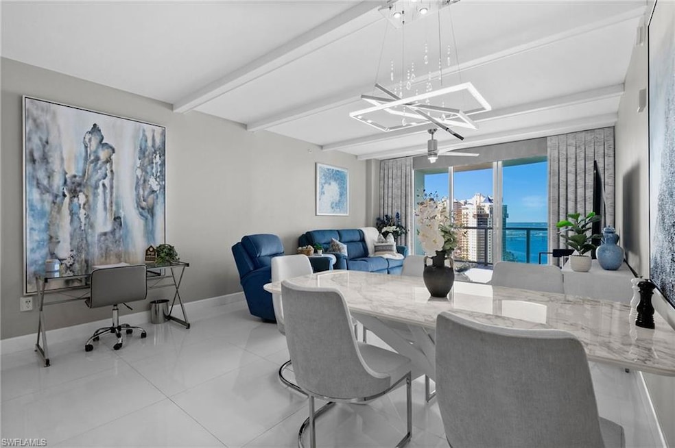 Tiled dining room featuring a water view