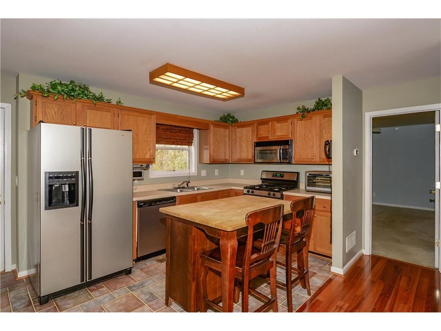 Open kitchen with butcher block island which remai