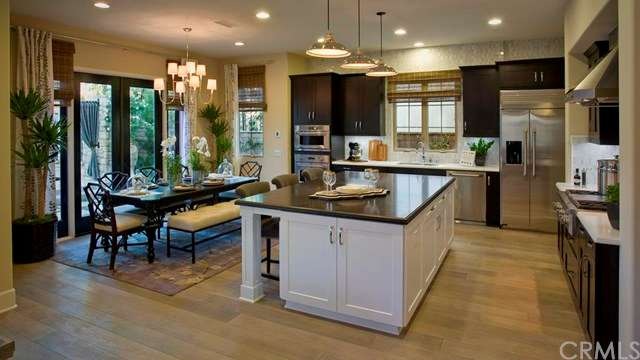 Dream kitchen features large kitchen island with bar seating and hardwood floors- as shown in model