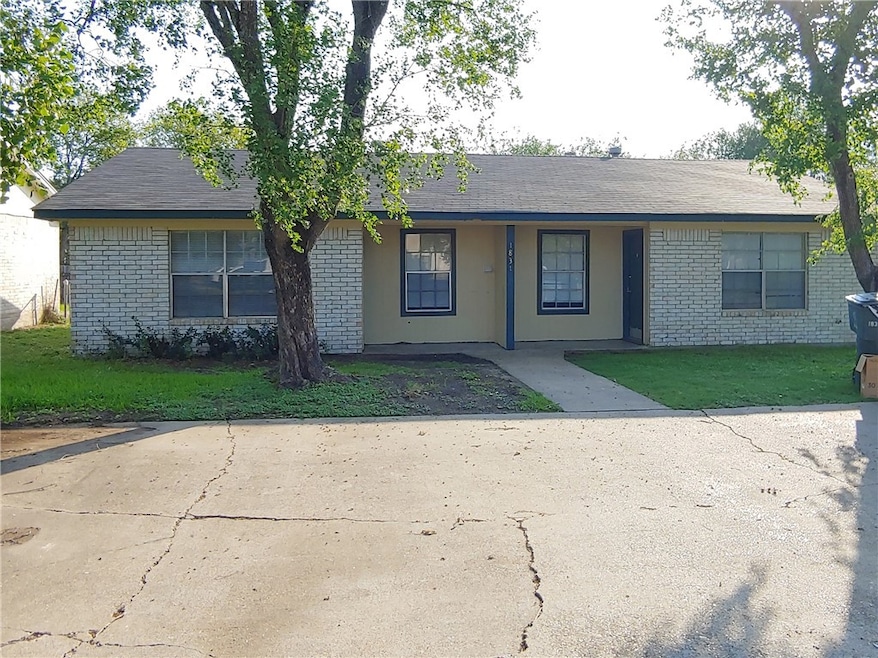 Single story home featuring brick siding and a fro