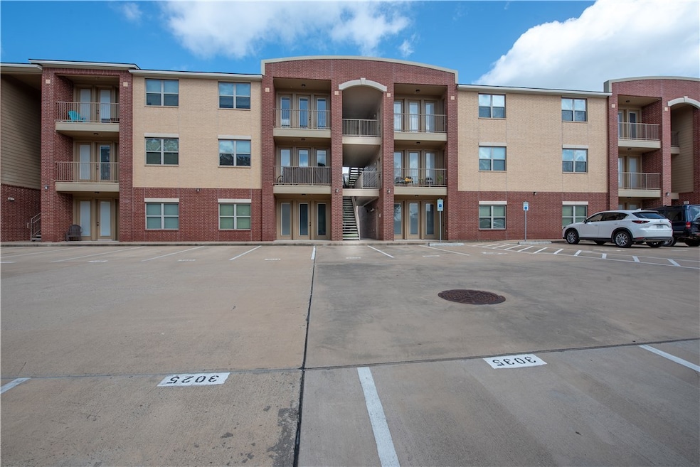 View of property with uncovered parking