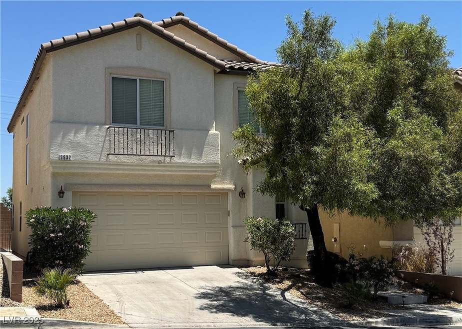 View of front facade with stucco siding, a garage,