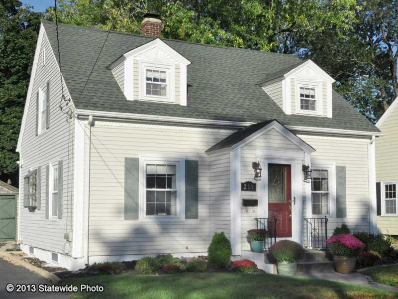 Exterior Front. Dormered cape with maintenance fre
