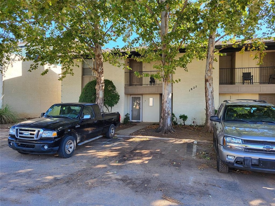 View of building exterior featuring uncovered parking