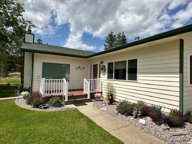 View of front of property featuring a front yard and a chimney