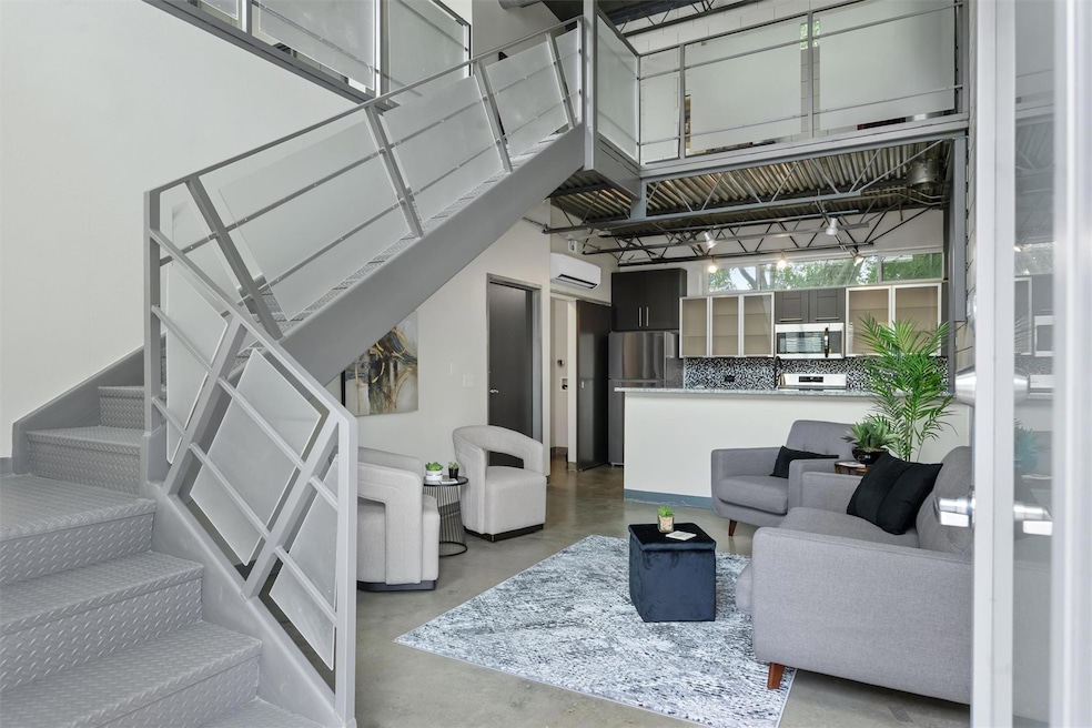 Living room with finished concrete floors, stairs