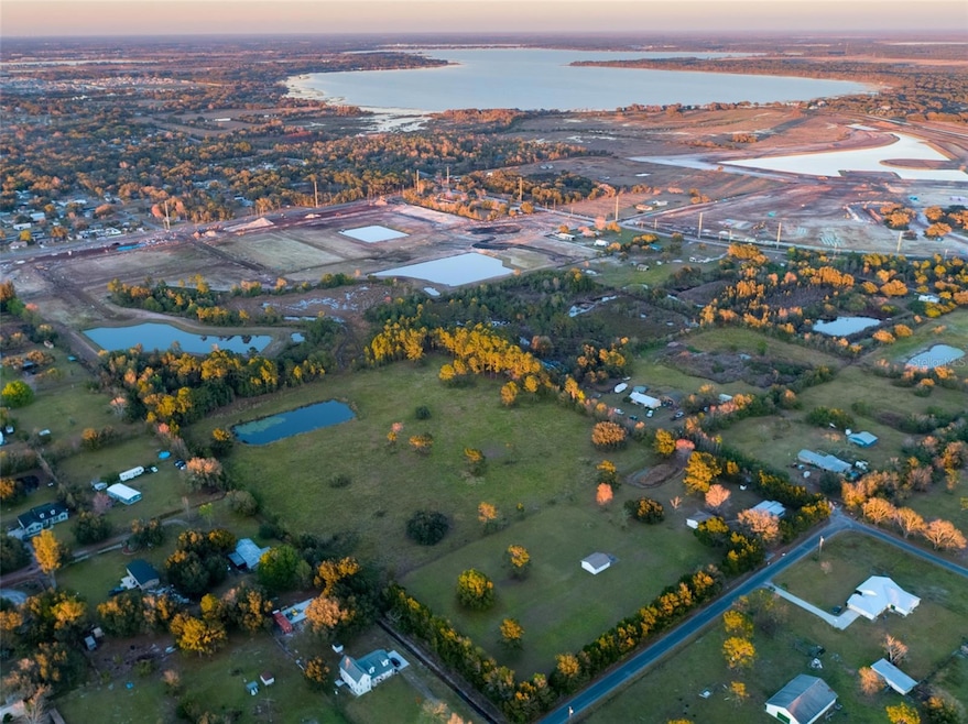 14.52 beautiful acres in the Manor, Alligator Lake in distance. National builders building to the north and to the east