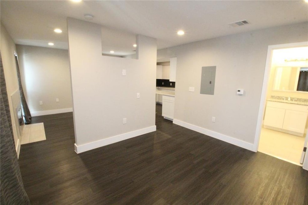 Unfurnished living room featuring electric panel,