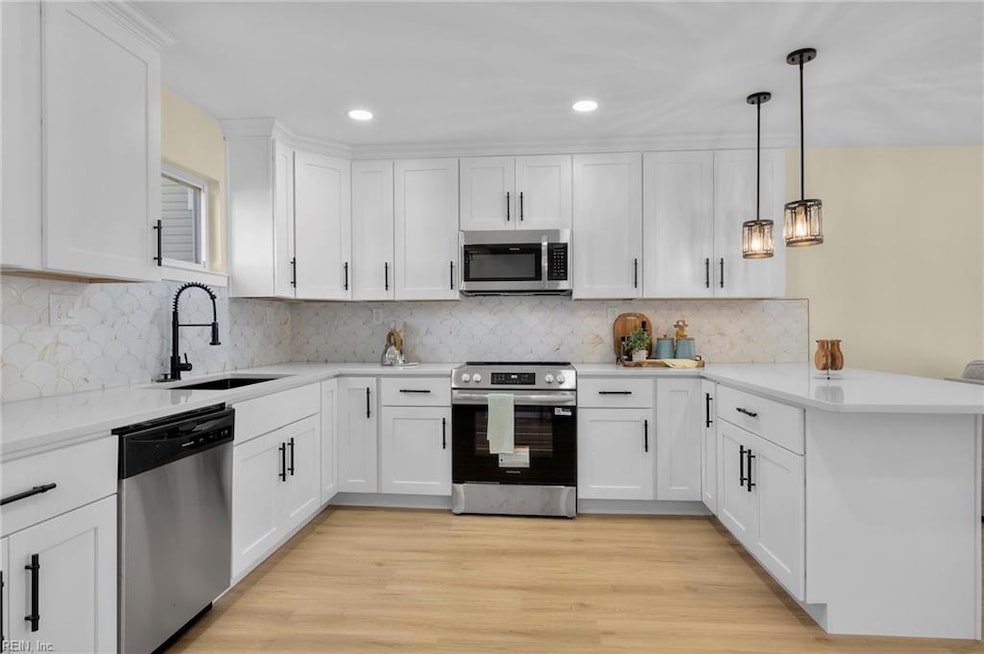 Beautiful kitchen with quartz countertops and tiled backsplash