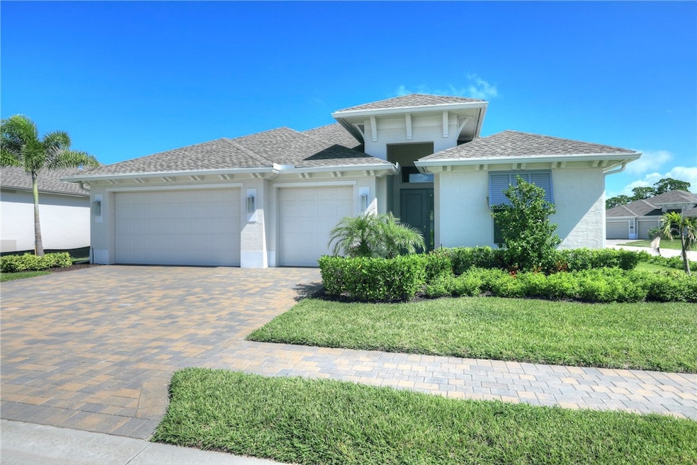 View of front facade featuring an attached garage, stucco siding, decorative driveway, and roof with shingles