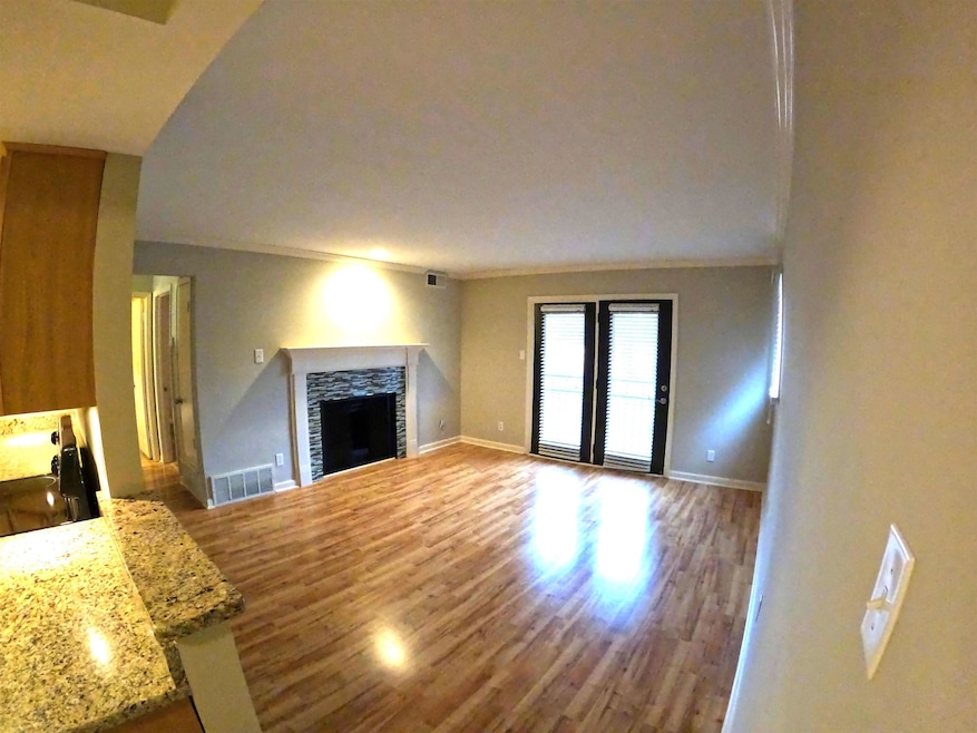 Unfurnished living room with crown molding, a fire