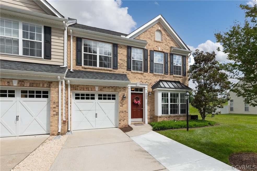 View of front of home with a garage and a front ya