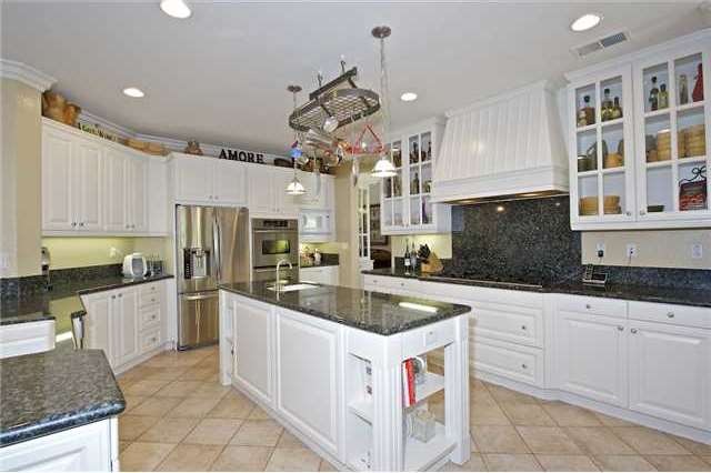 Open kitchen with marble counter tops, dual ovens 