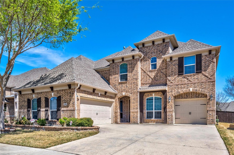 View of front of home with driveway, brick siding,