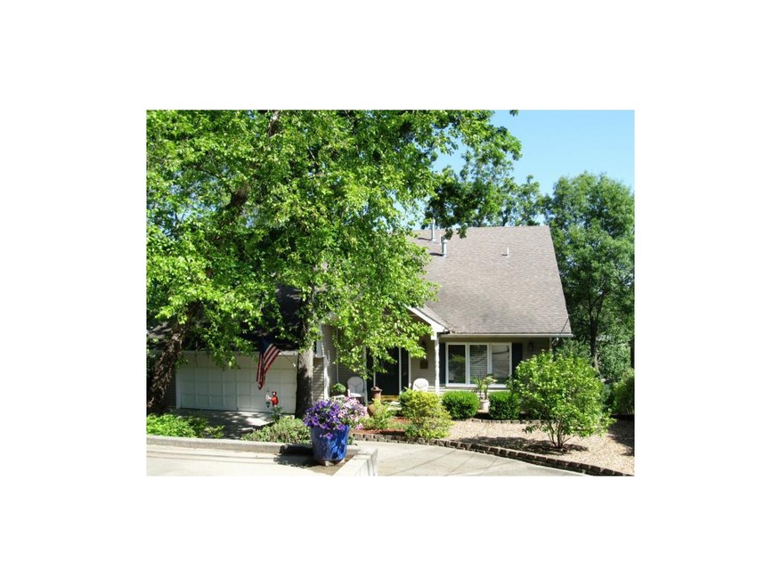 Front elevation with circular drive and parking pa
