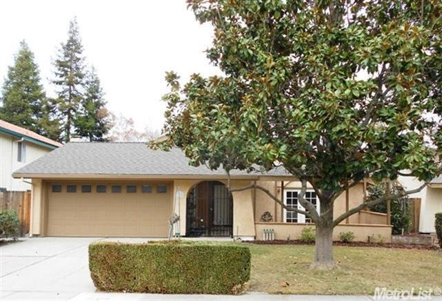 A beautiful Magnolia tree adorns the front yard