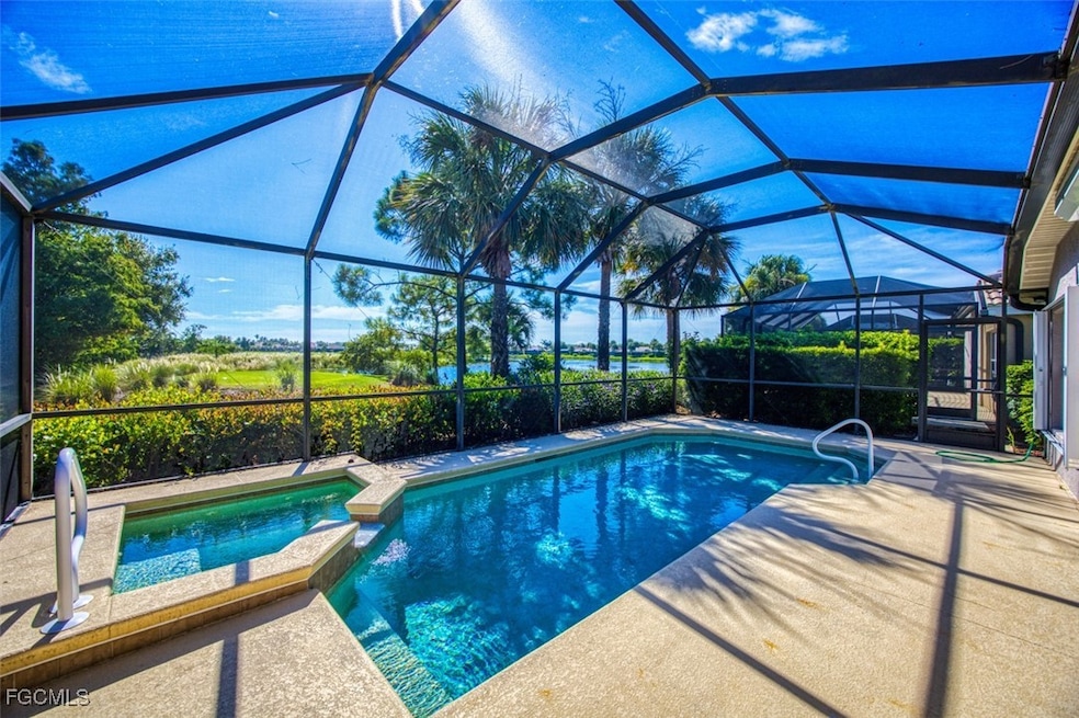 View of pool with a sunroom, a pool with connected hot tub, a patio area, and a lanai