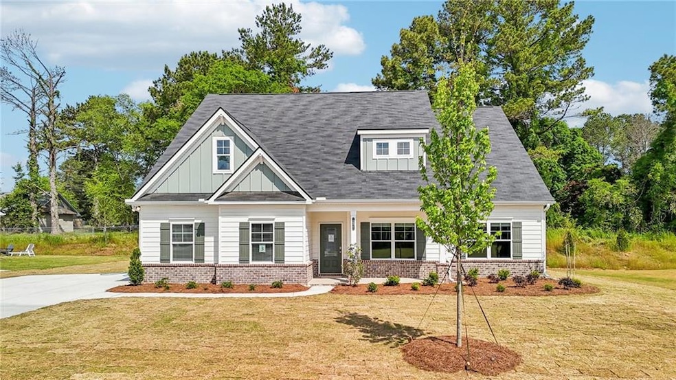 View of front of house with brick siding, board an