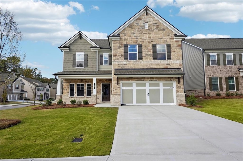 Craftsman-style house with a front yard and a gara