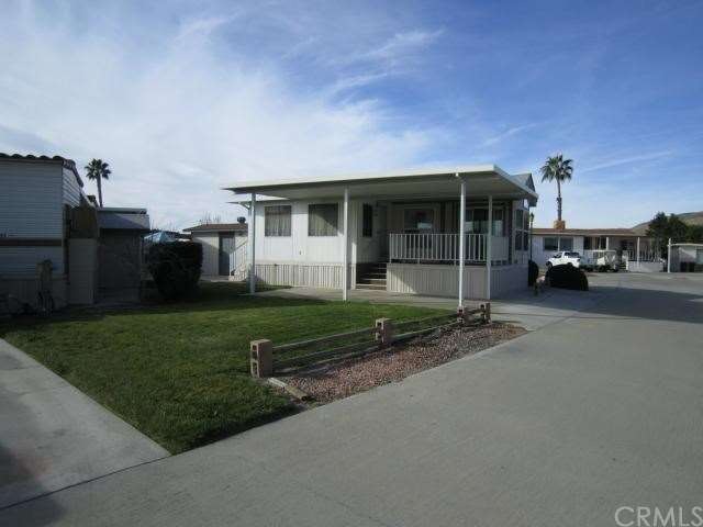 South side of home with lawn maintained by owner w