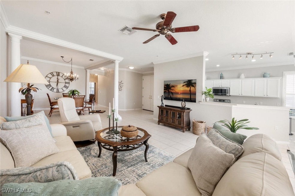 Living room featuring ceiling fan with notable cha