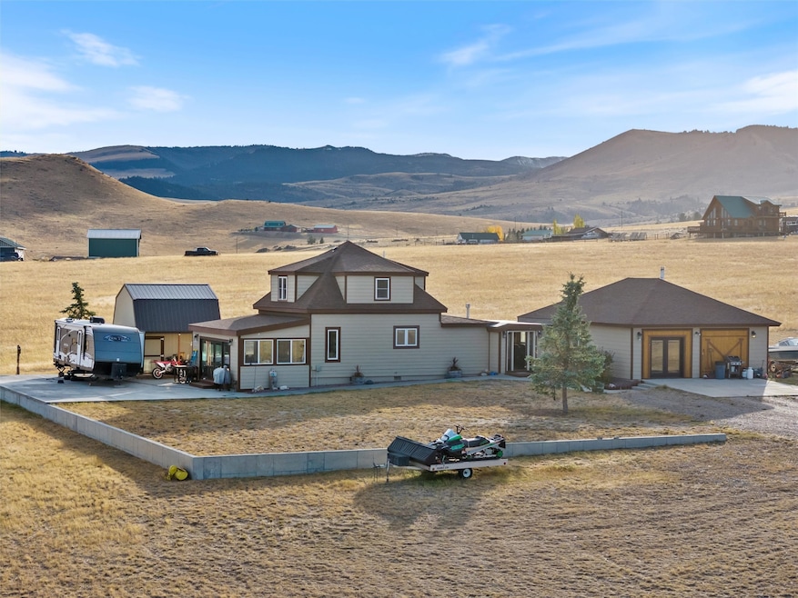 View of front facade with a mountain view and a garage
