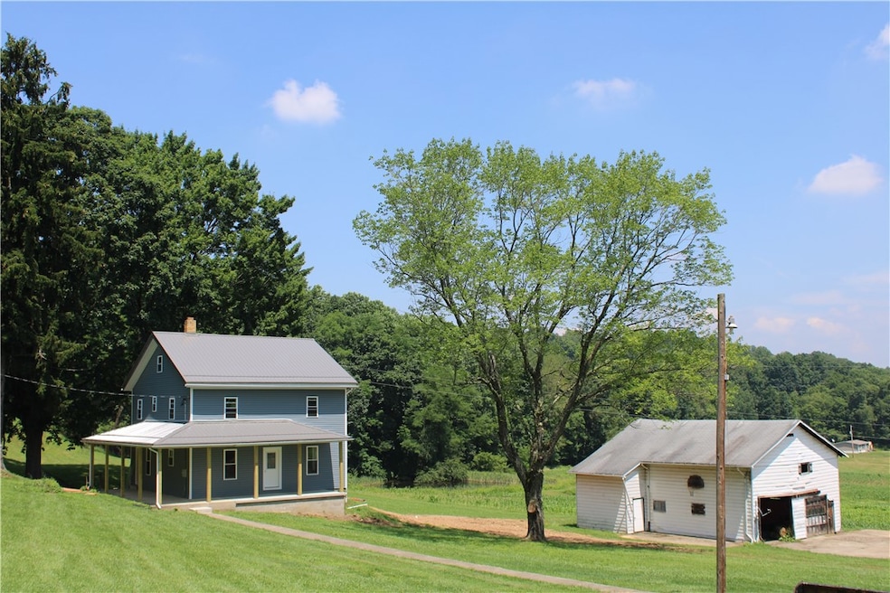 Quiet farmhouse surrounded by trees and cornfields